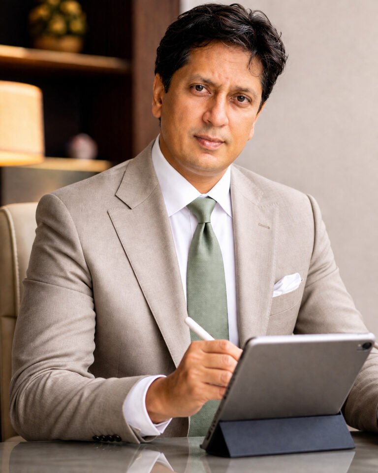 Dr Pavan Sonar, trusted and experienced psychiatrist in Mumbai, writing on iPad with calm and confident expression during consultation