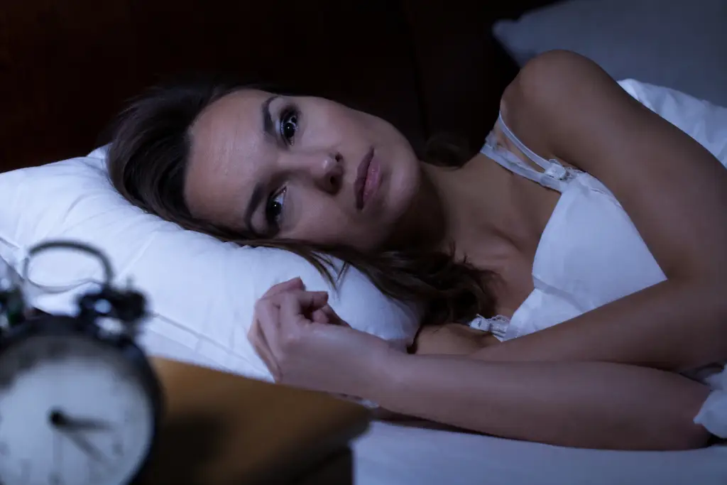 Woman lying awake at night suffering from insomnia and sleep disorder - Sleep specialist Dr Pavan Sonar Mumbai